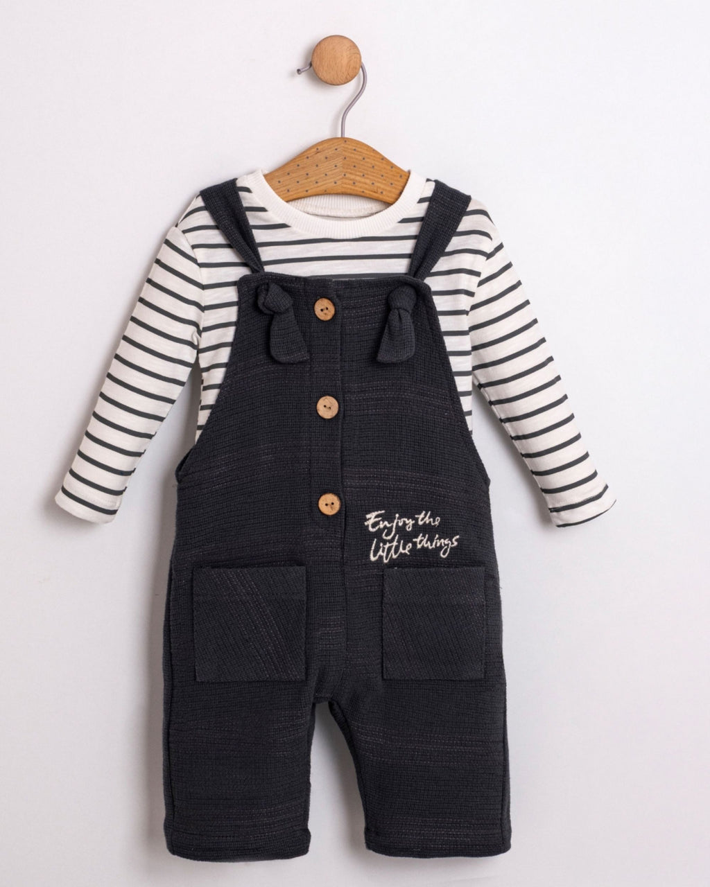 Baby boy navy dungarees with tie straps over a striped long-sleeve top, front view