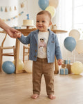 Baby boy wearing a blue knitted blazer and tan trousers at a birthday party