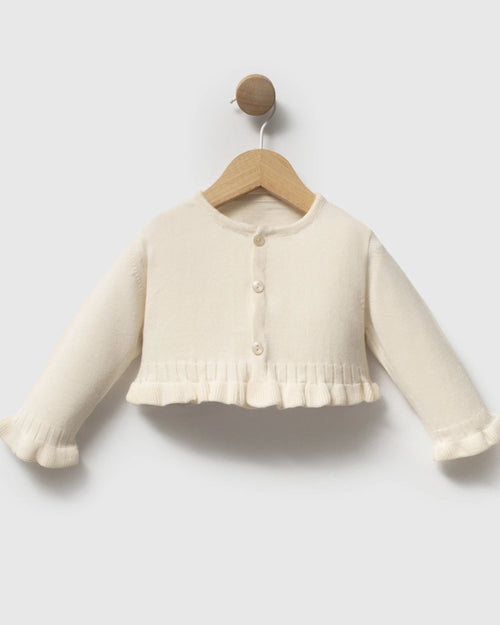 Baby girl cream knit cardigan with frilled hem and cuffs, front view on hanger