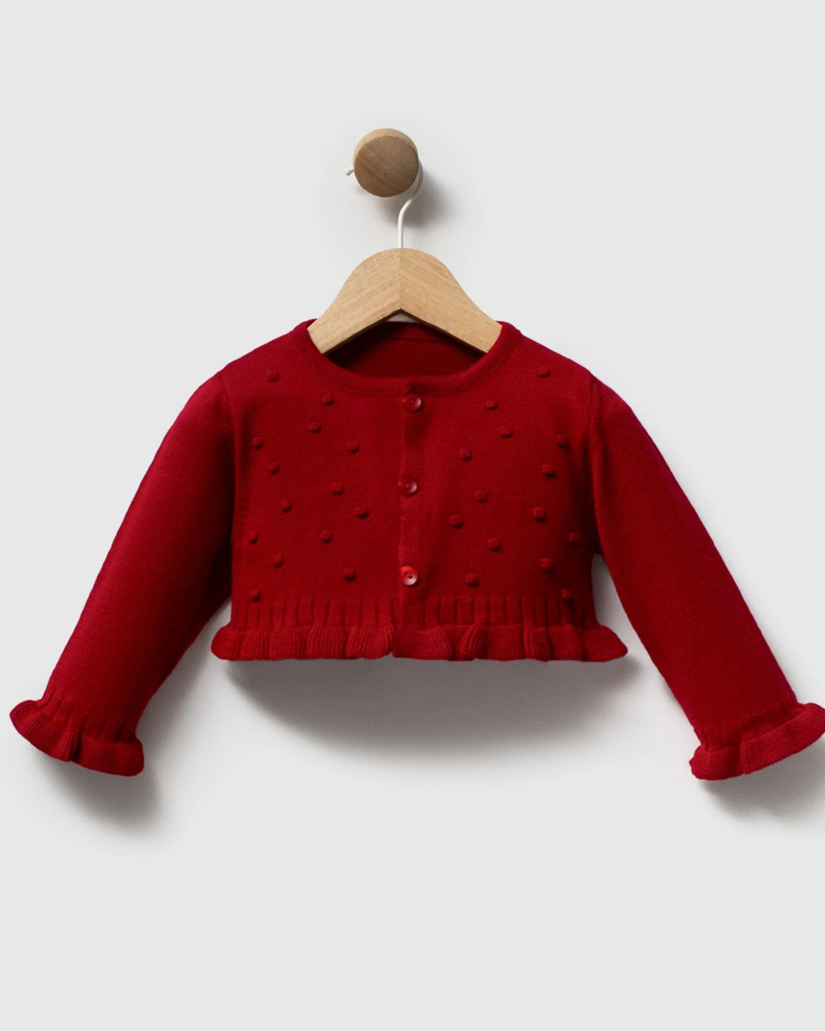 Baby girl red bobble knit cardigan with frilled hem, front view on hanger