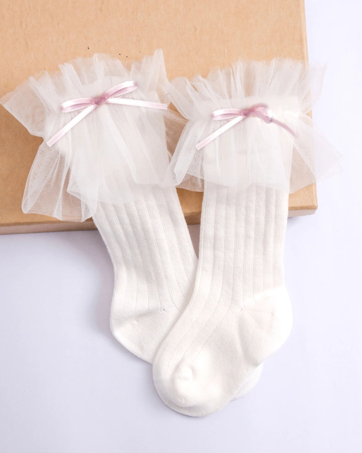 White tulle frill knee socks styled with a baby girl party dress
