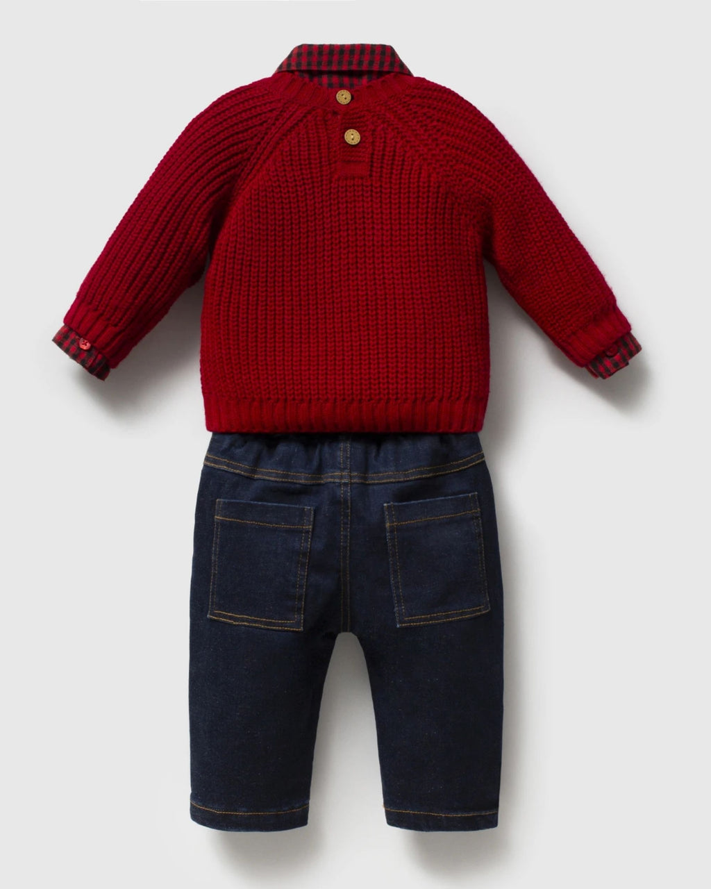 Baby boy red teddy jumper outfit laid out by a Christmas tree
