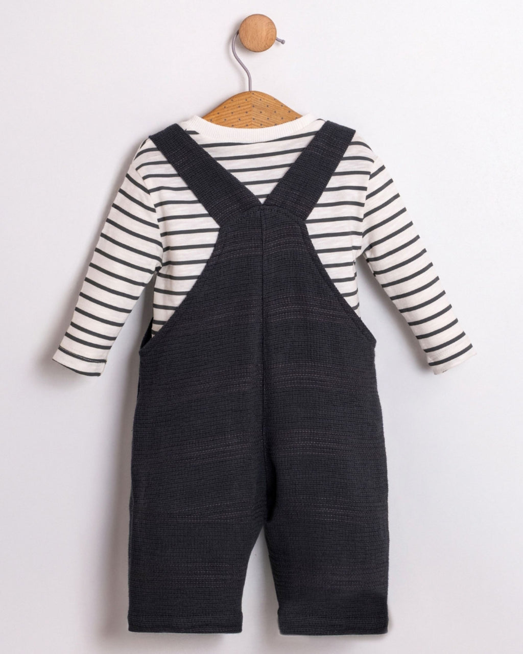 Back view of navy baby boy dungarees with crossed straps