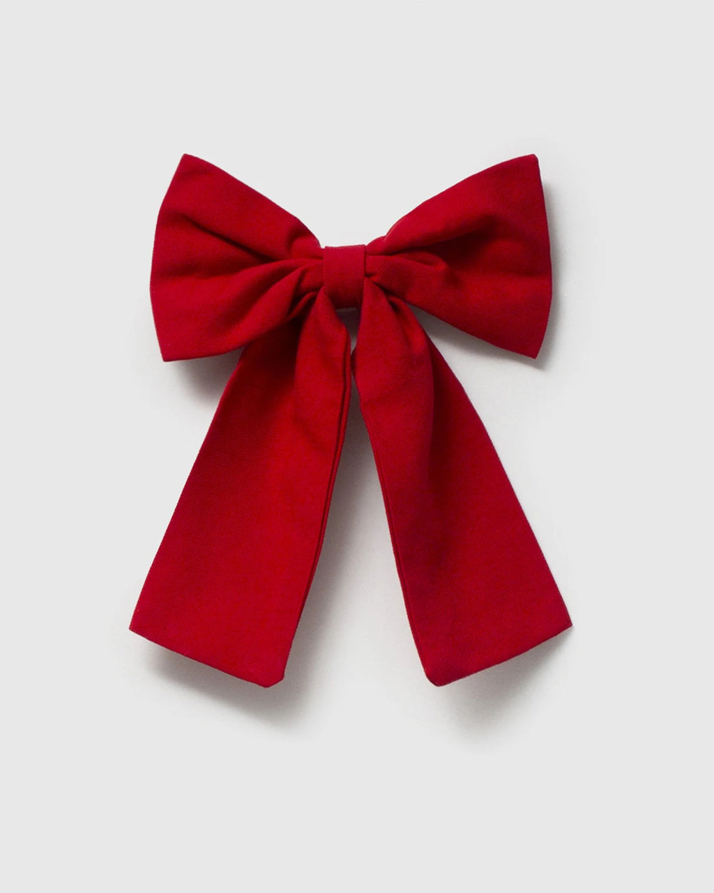 Back of red bow hair clip showing the clip fastening