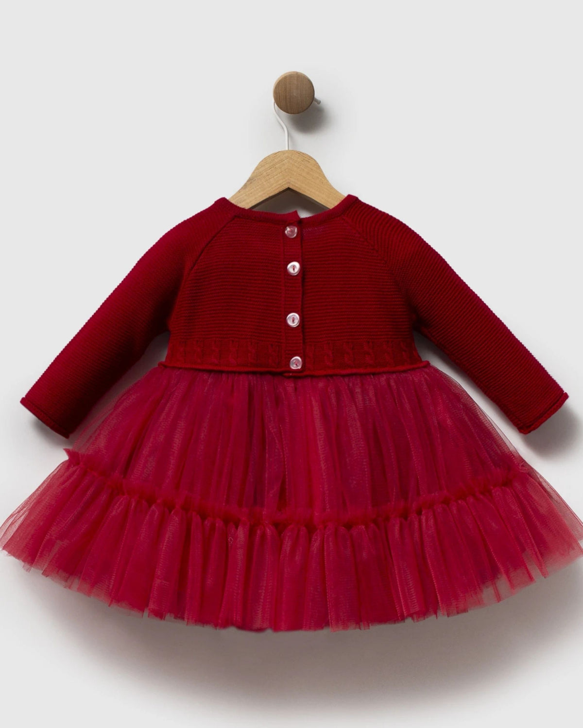 Back of red knit and tulle baby dress with button fastening