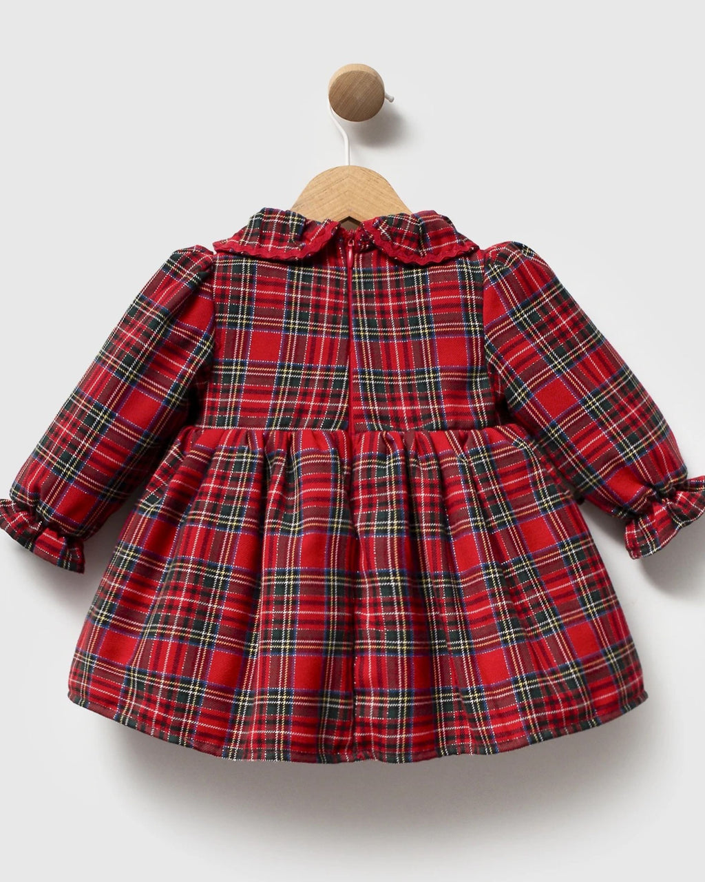 Back of red tartan baby dress showing zip fastening and full gathered skirt